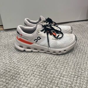 On Running White and Orange Sneakers with Chunky Sole and Sleek Design